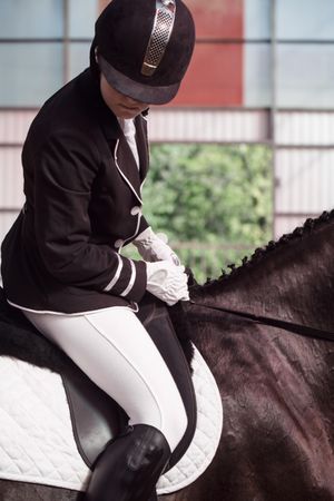 Horseback rider in uniform practicing dressage
