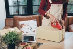 Female business owner preparing boxes for shipping