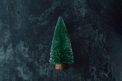 Miniature Christmas tree on dark marble table