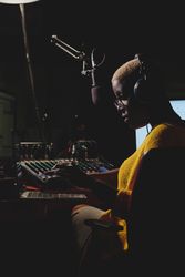 Serious Black woman working at radio station