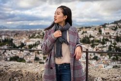 Cheerful woman visiting ancient city