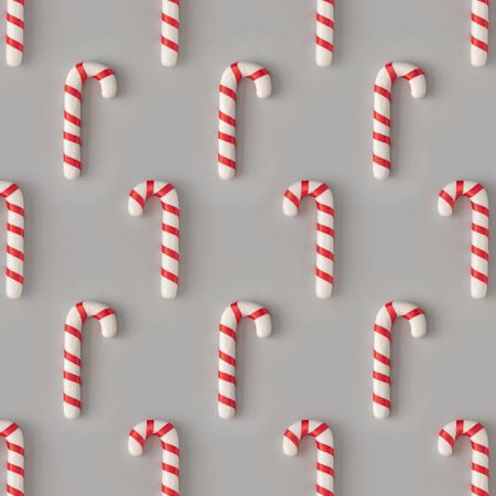 Holiday pattern with candy canes on gray background