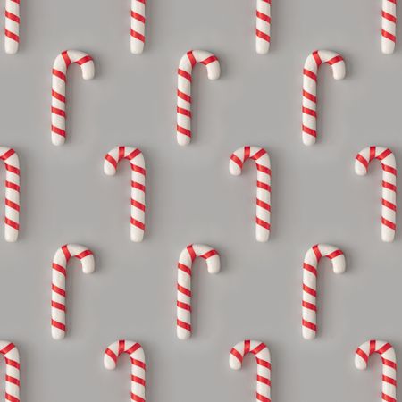 Holiday pattern with candy canes on gray background
