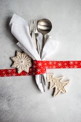 Christmas cutlery wrapped in red ribbon