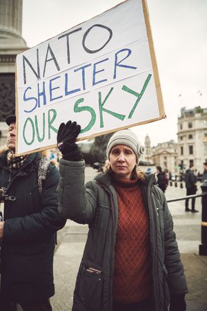 London, England, United Kingdom - March 5 2022: Woman with sign about NATO at anti-war protest