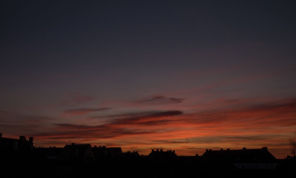 Orange red sky over French rooftops