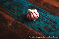 Purple garlic bulb on wooden table 5zdmmb