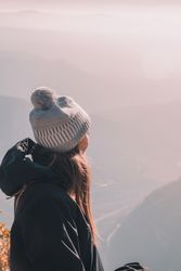 Woman in coat on hill