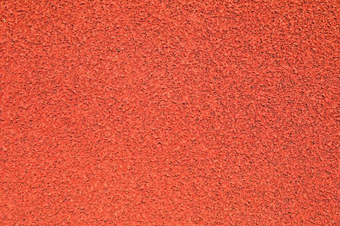Red rubber running track background, top view