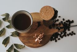 Mug and decorative elements on wooden stand on table
