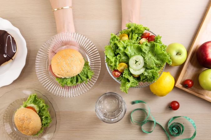 Top View Female hand with Burger and Salad