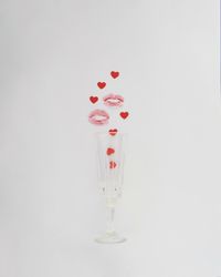 Champagne flute with lipstick mark and hearts