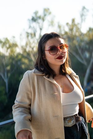 Portrait  of smiling young woman with sunglasses and shoulder length straight hair