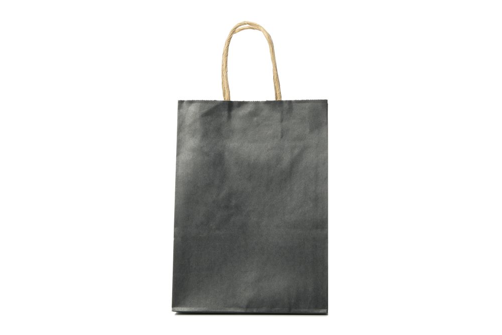 dark paper bag isolated on light background