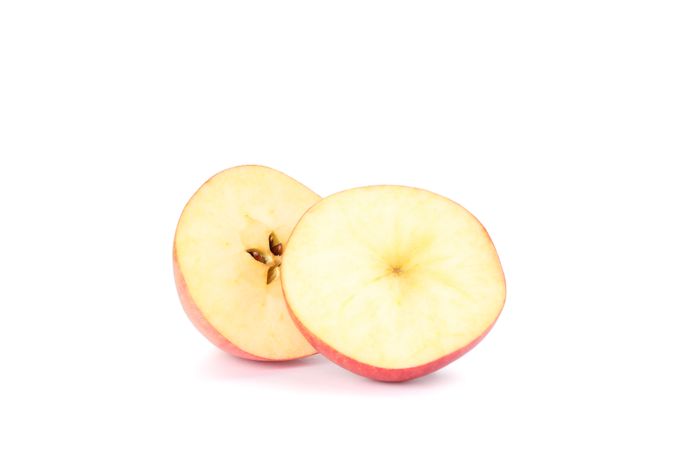 Slices of apple isolated on light background
