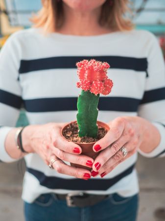 Female with blooming cactus plant