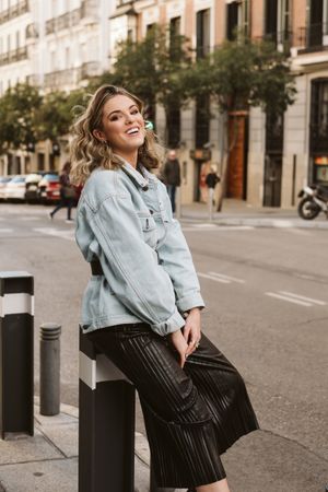 Stylish woman sitting in a bollard