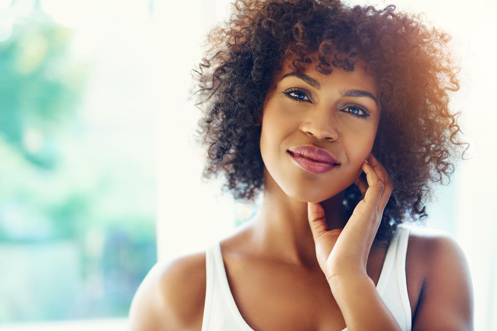 Portrait of female with curly hair with head tilted