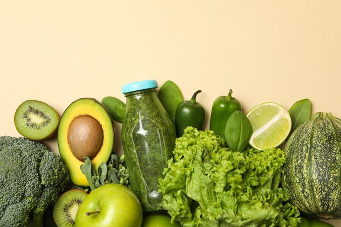 Vegetables, fruits and smoothie on beige background