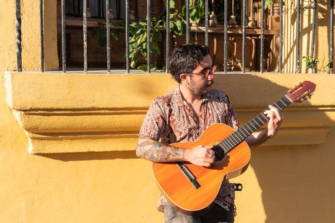 Young Scruffy Musician Plays On The Street