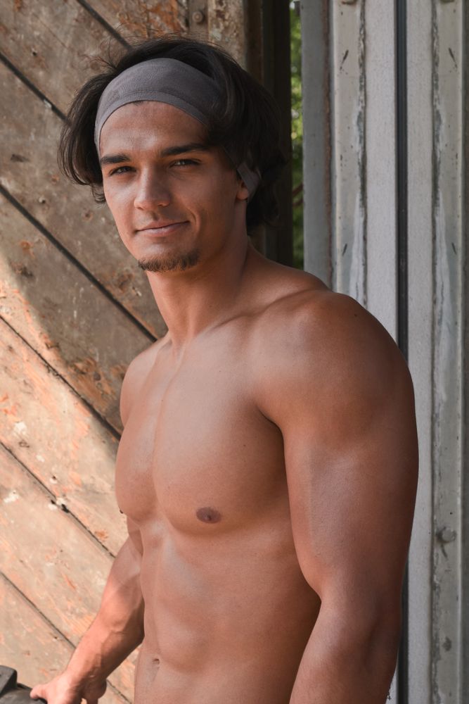Muscular man posing in gym