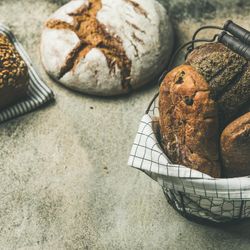 Baked bread loaves on table and in basket