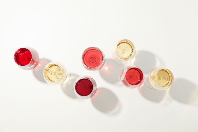 Flat lay composition. Glasses with different wine on plain background, top view