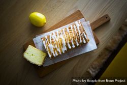Top view of lemon cake on wooden cutting board 43r715