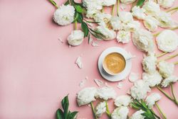 Top view of morning coffee surrounded by spring flowers