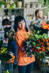Woman holding flowers in the flower shop.