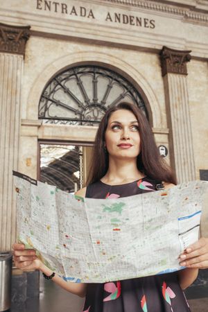 Woman with map at train station