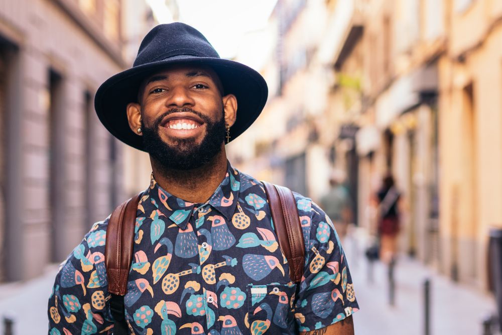 Stylish Black man walking on the city street