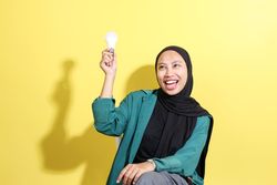 Asian Hijab Woman Holding Light Bulb, Idea Concept.