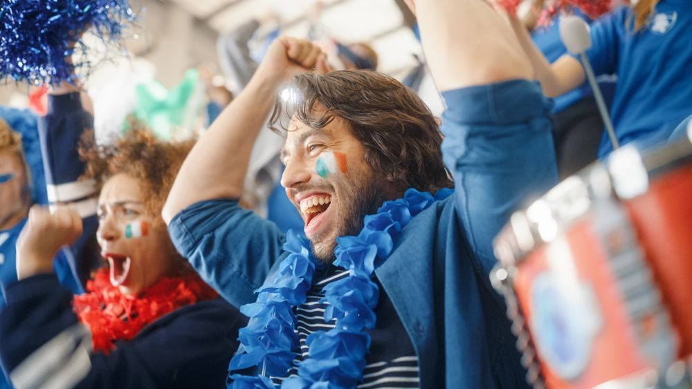 Sport Stadium Soccer Match: Portrait of Bi Racial Couple with Italian Flag Painted Faces Cheering Team to Win