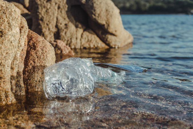 Plastic bottle lying on seashore