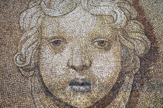 Ancient mosaic in warm hues at aged temple