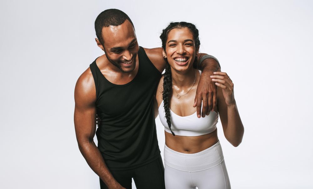 Portrait of happy young people wearing activewear working out