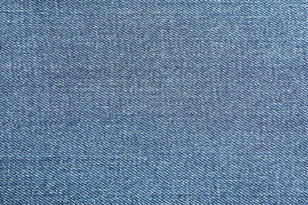 Texture of blue jeans as background, space for text