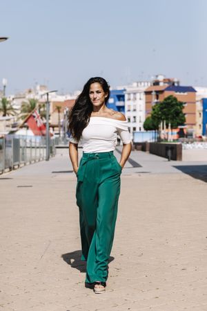 woman walking on street hands on pocket