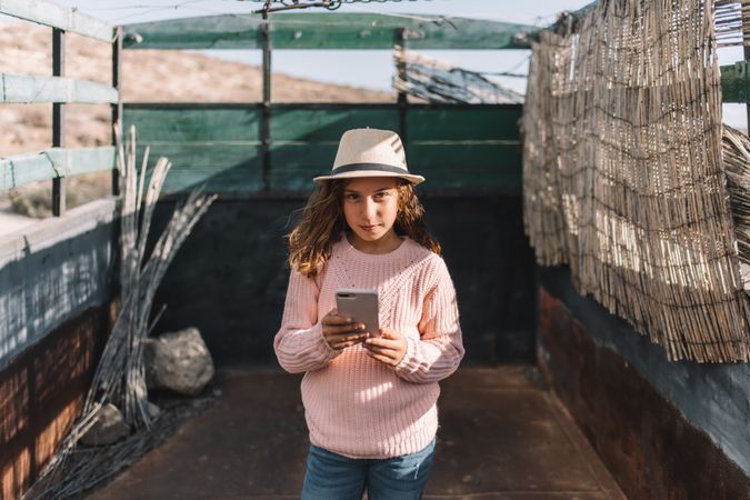 Focused girl using smartphone in countryside