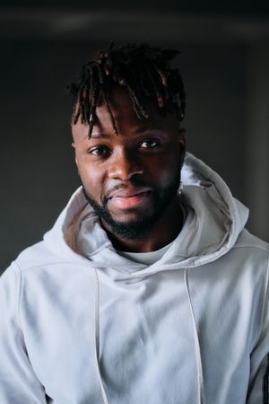 Smiling cheerful man in hoodie looking at camera