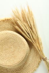 Top view of hat and bunch of dried flowers, vertical
