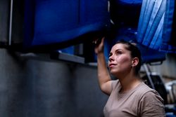 Military woman looking up inside vehicle