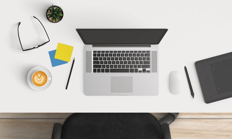 Modern workplace with laptop and smartphone copy space on table background. Top view. Flat lay style.