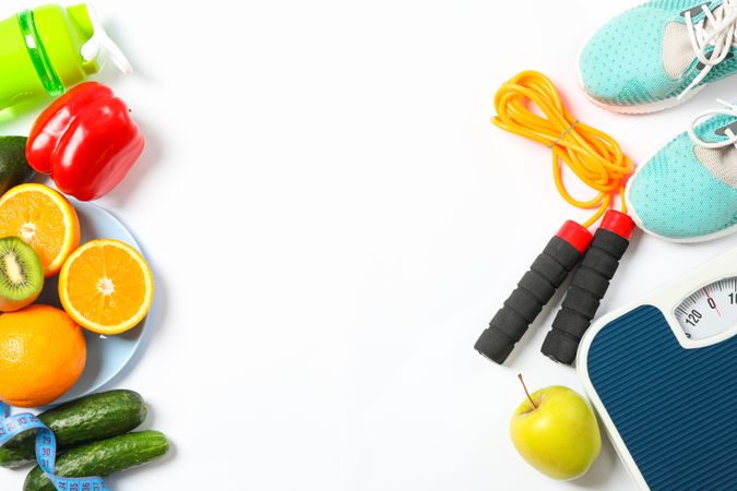Healthy lifestyle accessories on blank background, top view