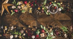 Holiday decorations of stars, baubles, leaves, and ribbon, with copy space