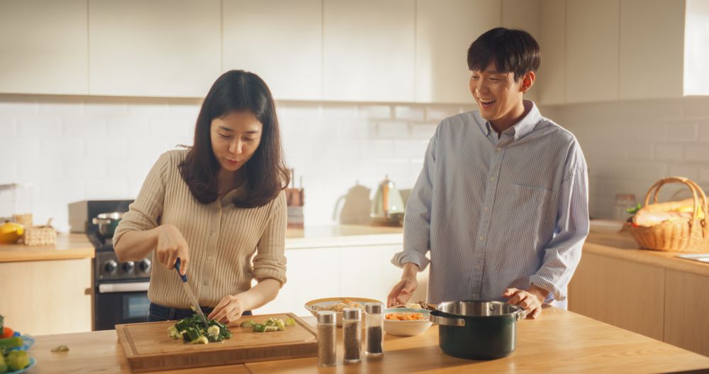 Portrait of a South Korean Young Couple Cooking at Home.