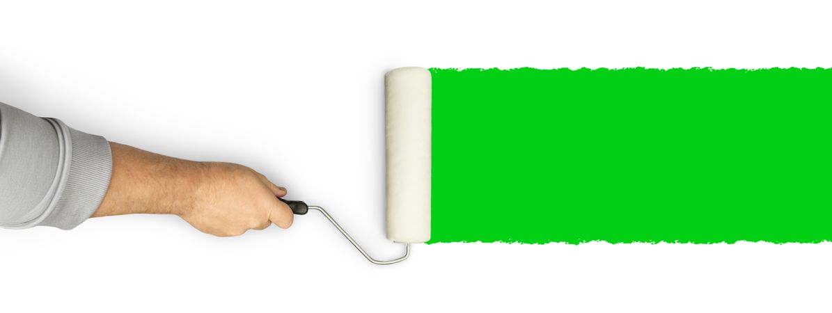 Male Hand Rolling Paint Roller Over Green Screen Background.