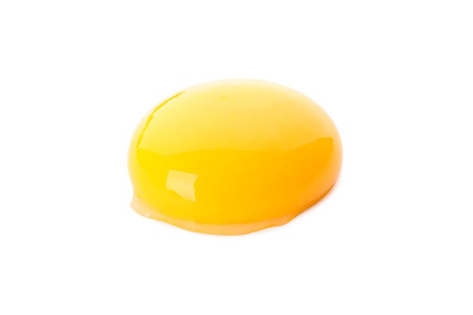 Raw egg yolk isolated on plain background