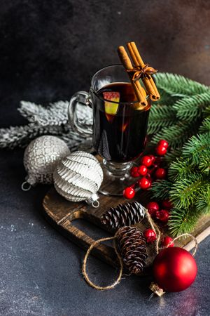 Mulled wine on wooden board with Christmas decorations